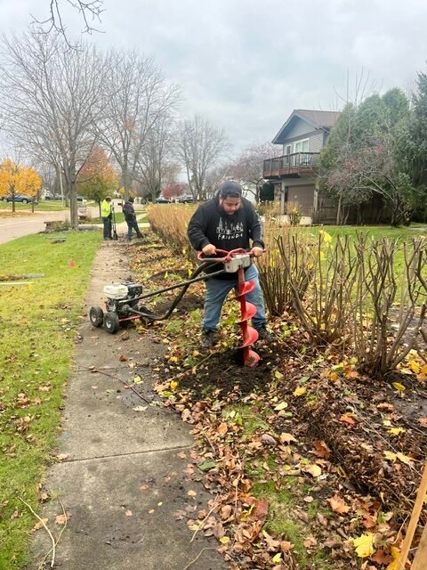 The contractors digging holes and building fences